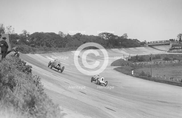 Sir Henry Birkin's Bentley racing RJ Munday's Vauxhall 30/98, BARC meeting, Brooklands, 16 May 1932. Artist: Bill Brunell.