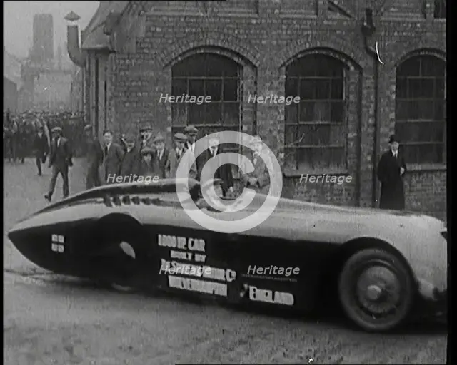 Sir Henry Segrave AKA Major Segrave's Driving  'Sunbeam' Out of a Factory Watched By a..., 1927. Creator: British Pathe Ltd.
