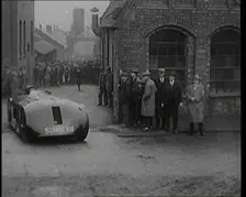 Sir Henry Segrave AKA Major Segrave's Driving Sunbeam Out of a Factory Watched By a..., 1927. Creator: British Pathe Ltd
