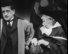 Sir James Barrie and Elen Terry Sitting Together in Academic Dress Outside St Andrew's Uni..., 1922. Creator: British Pathe Ltd