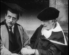 Sir James Barrie and Ellen Terry Sitting Together in Academic Dress Outside St Andrew's Uni, 1922. Creator: British Pathe Ltd