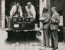 Sir Walter Lamb and Zhuang Shangyan (Chuang Shang-yen) checking cases as they arrive at..., 1935. Creator: Topical Press Agency