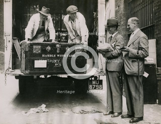 Sir Walter Lamb and Zhuang Shangyan (Chuang Shang-yen) checking cases as they arrive at..., 1935.  Creator: Topical Press Agency.