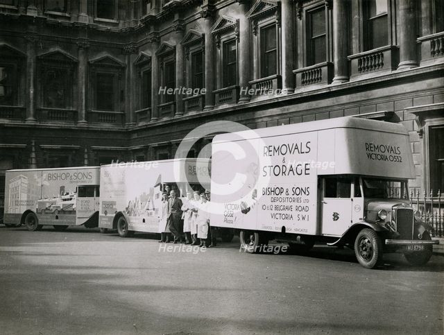 Sir Walter Lamb with vans and staff from Bishop & Sons Depositories outside Burlington House, 1935. Creator: Topical Press Agency.