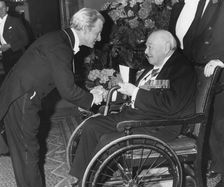 Sir Winston Churchill is greated by Sir Charles Wheeler on his arrival at Burlington House, 1963