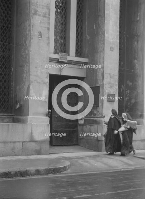 Sisters of Charity and the gateway of the Armory, New Orleans, between 1920 and 1926. Creator: Arnold Genthe.