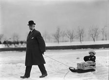Skating Party - Unidentified Man Pulling Child On Sled, 1912. Creator: Harris & Ewing