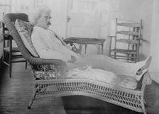 S.L. Clemens reclining in porch chair, 1910. Creator: Bain News Service