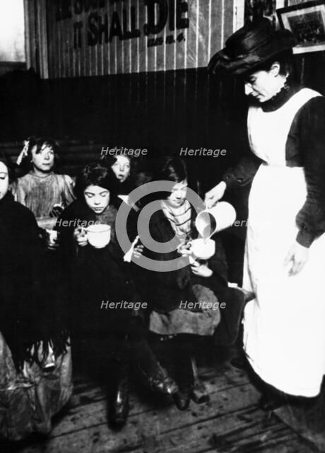Slum sister giving out farthing breakfast, London. Artist: Unknown