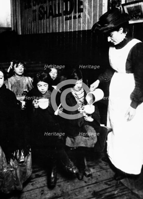 Slum sister giving out farthing breakfast, London. Creator: Unknown.