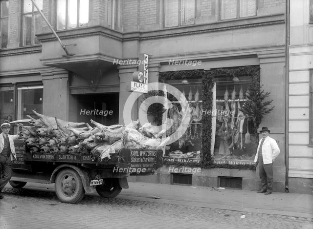 Slaughtered pigs on a lorry outside the butcher's shop. Landskrona, Sweden, 1933. Creator: Unknown.