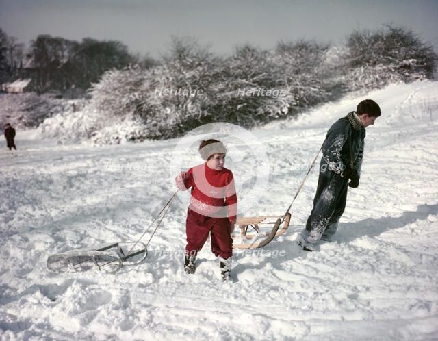 Sledging on Hampstead Heath, London, c1955.  Creator: Arthur Charles Kirby Ware.