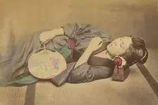 Sleeping Japanese woman holding a fan, 1868-1880. Creator: Felice Beato
