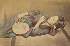Sleeping Japanese woman holding a fan, 1868-1880. Creator: Felice Beato