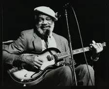 Slim Gaillard playing his guitar at the Forum Theatre, Hatfield, Hertfordshire, 13 November 1986. Creator: Denis Williams
