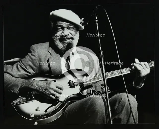 Slim Gaillard playing his guitar at the Forum Theatre, Hatfield, Hertfordshire, 13 November 1986. Creator: Denis Williams.