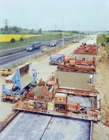 Slipform paving machines laying a road surface during widening works on the M1, 18/05/1982. Creator: John Laing plc