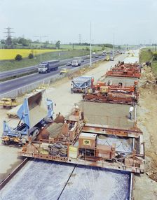 Slipform paving machines laying a road surface during widening works on the M1, 18/05/1982. Creator: John Laing plc