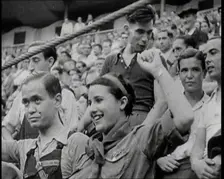 Spectators at Bullring Cheering Parading Government Fighters, Including Woman With Raised..., 1937. Creator: British Pathe Ltd