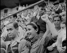 Spectators at Bullring Cheering Parading Government Fighters, Including Woman With Raised..., 1937. Creator: British Pathe Ltd