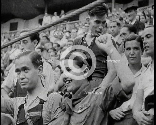 Spectators at Bullring Cheering Parading Government Fighters, Including Woman With Raised..., 1937. Creator: British Pathe Ltd.