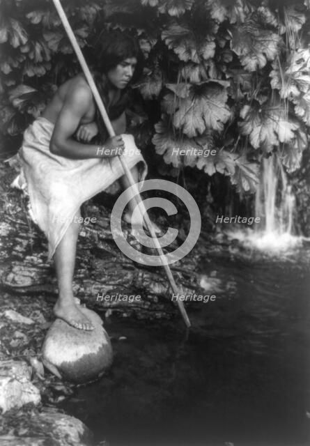 Spearing salmon, c1923. Creator: Edward Sheriff Curtis.