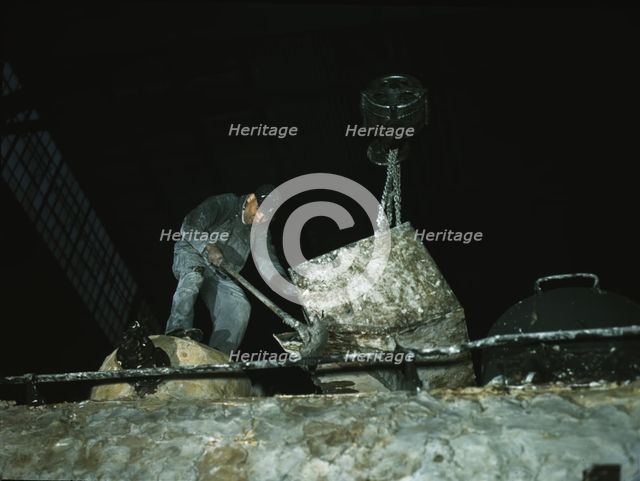 Spreading asbestos mixture on boiler of a locomotive, C & NW RR, 40th Street locomotive shops, 1942. Creator: Jack Delano.