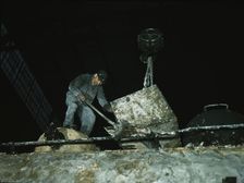 Spreading asbestos mixture on boiler of a locomotive, C & NW RR, 40th Street locomotive shops, 1942. Creator: Jack Delano