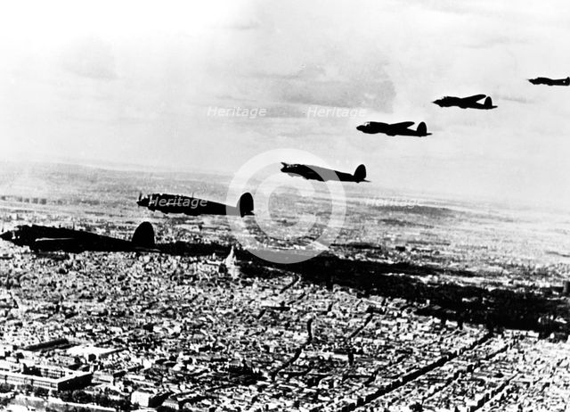 Squadron of German Heinkel He 111 bombers flying over occupied Paris, July 1940. Artist: Unknown