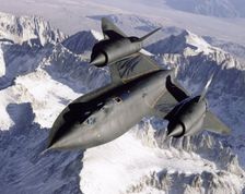 SR-71 over snow-capped mountains, USA, 1995. Creator: NASA
