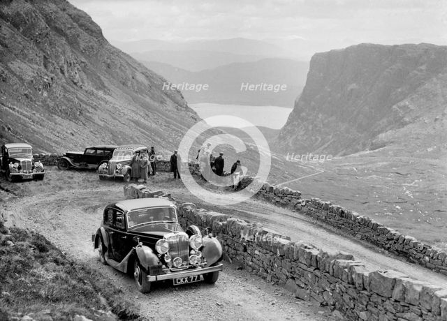 SS Jaguar saloon of DS Hand competing in the RSAC Scottish Rally, 1936. Artist: Bill Brunell.