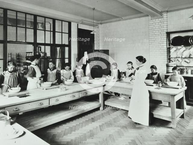 Student teacher in a cookery lesson, Battersea Polytechnic, London, 1907. Artist: Unknown.