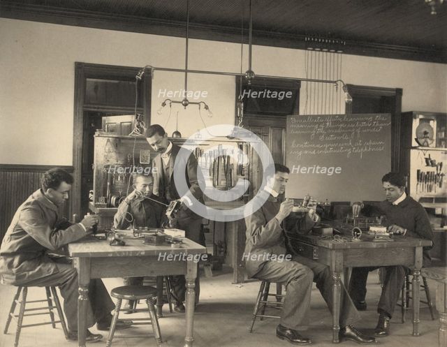 Students constructing telephones at Hampton Institute, 1899 or 1900. Creator: Frances Benjamin Johnston.