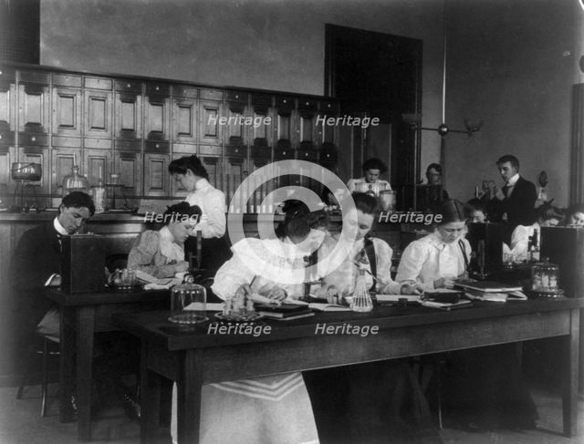 Students in a science class using microscopes, Western High School, Washington, D.C., (1899?). Creator: Frances Benjamin Johnston.