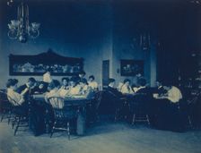Students seated around tables, studying, at Western High School, Washington, D.C., (1899?). Creator: Frances Benjamin Johnston