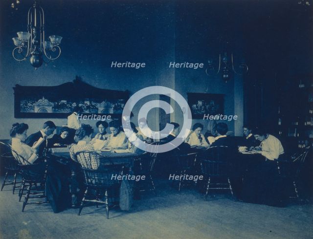 Students seated around tables, studying, at Western High School, Washington, D.C., (1899?). Creator: Frances Benjamin Johnston.