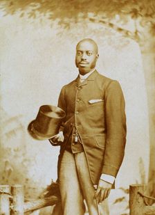 Studio portrait of man with top hat and cane, c1880-c1889. Creator: George E. Curtis