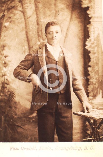 Studio portrait of man, hand on waist, (1880-1940?). Creator: Van Orsdell.
