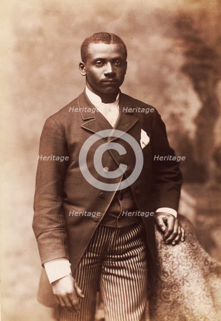 Studio portrait of a man dressed in jacket, vest, tie and striped pants, c1880-c1889. Creator: Alexander Hesler.