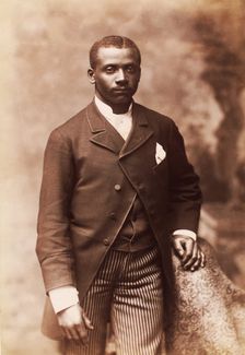 Studio portrait of a man dressed in jacket, vest, tie and striped pants, c1880-c1889. Creator: Alexander Hesler