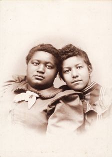 Studio portrait of two young women, heads touching, c1890-c1899. Creators: R. D. Cochran, Unknown