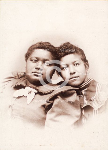 Studio portrait of two young women, heads touching, c1890-c1899. Creators: R. D. Cochran, Unknown.