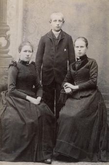 Studio portrait of three siblings, c1900