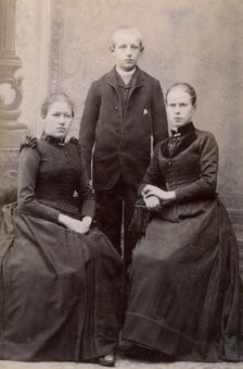 Studio portrait of three siblings, c1900. Creator: Unknown