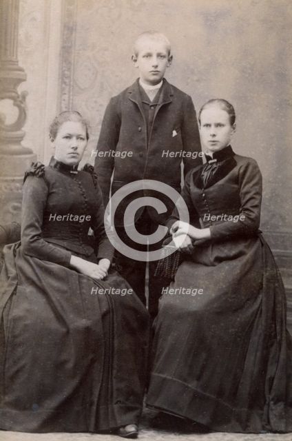 Studio portrait of three siblings, c1900. Creator: Unknown.