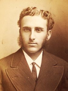 Studio portrait of unidentified man with long sideburns and wavy hair, c1870-c1879. Creator: Moses Parker Rice