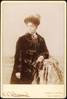 Studio portrait of woman wearing hat, and velvet coat, c1880-c1889. Creators: O.C. Benjamin, Unknown