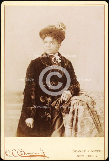 Studio portrait of woman wearing hat, and velvet coat, c1880-c1889. Creators: O.C. Benjamin, Unknown.