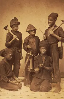 Studio portrait of young chimney sweeps, c1870. Creator: J. N. Wilson