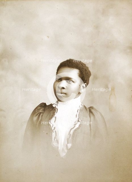 Studio portrait of young woman, c1890-c1899. Creators: M Yogg, Unknown.